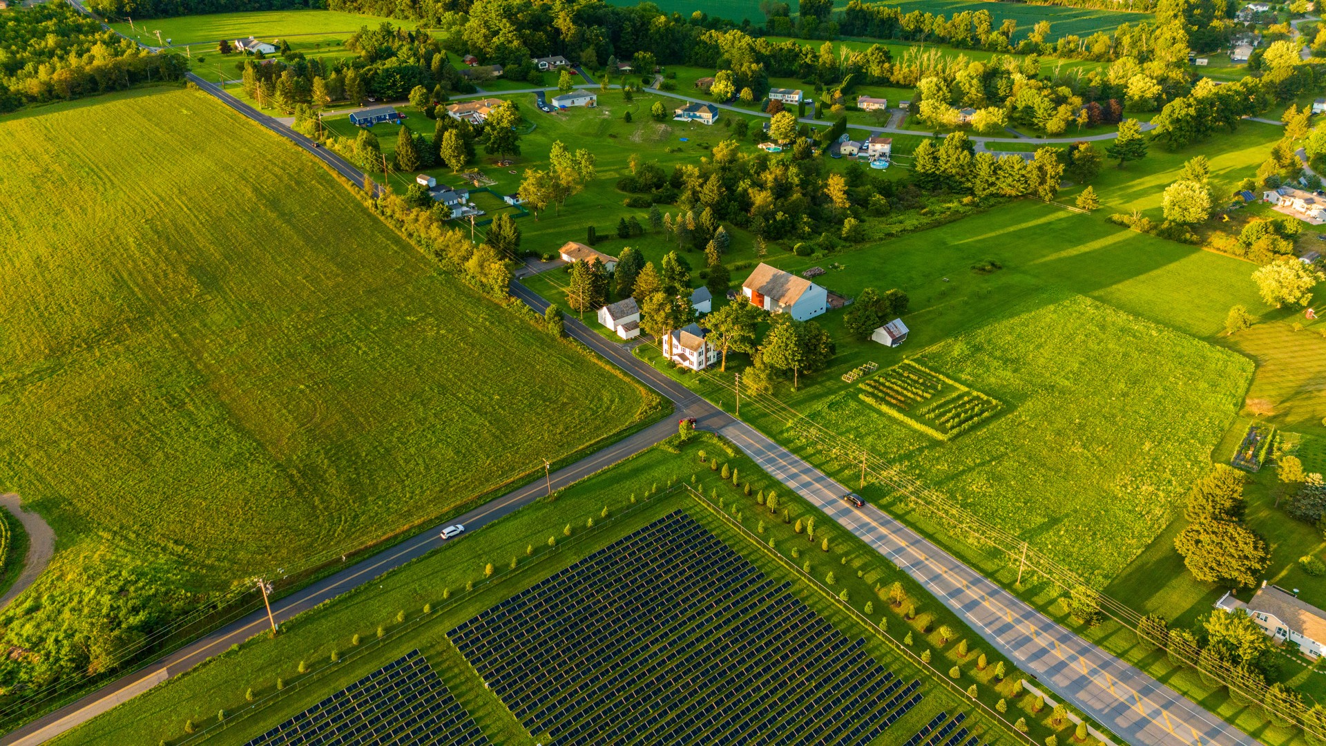 Highway stretching along agricultural fields with solar panels in rural Chestnuthill Township, Monroe County, Pennsylvania.