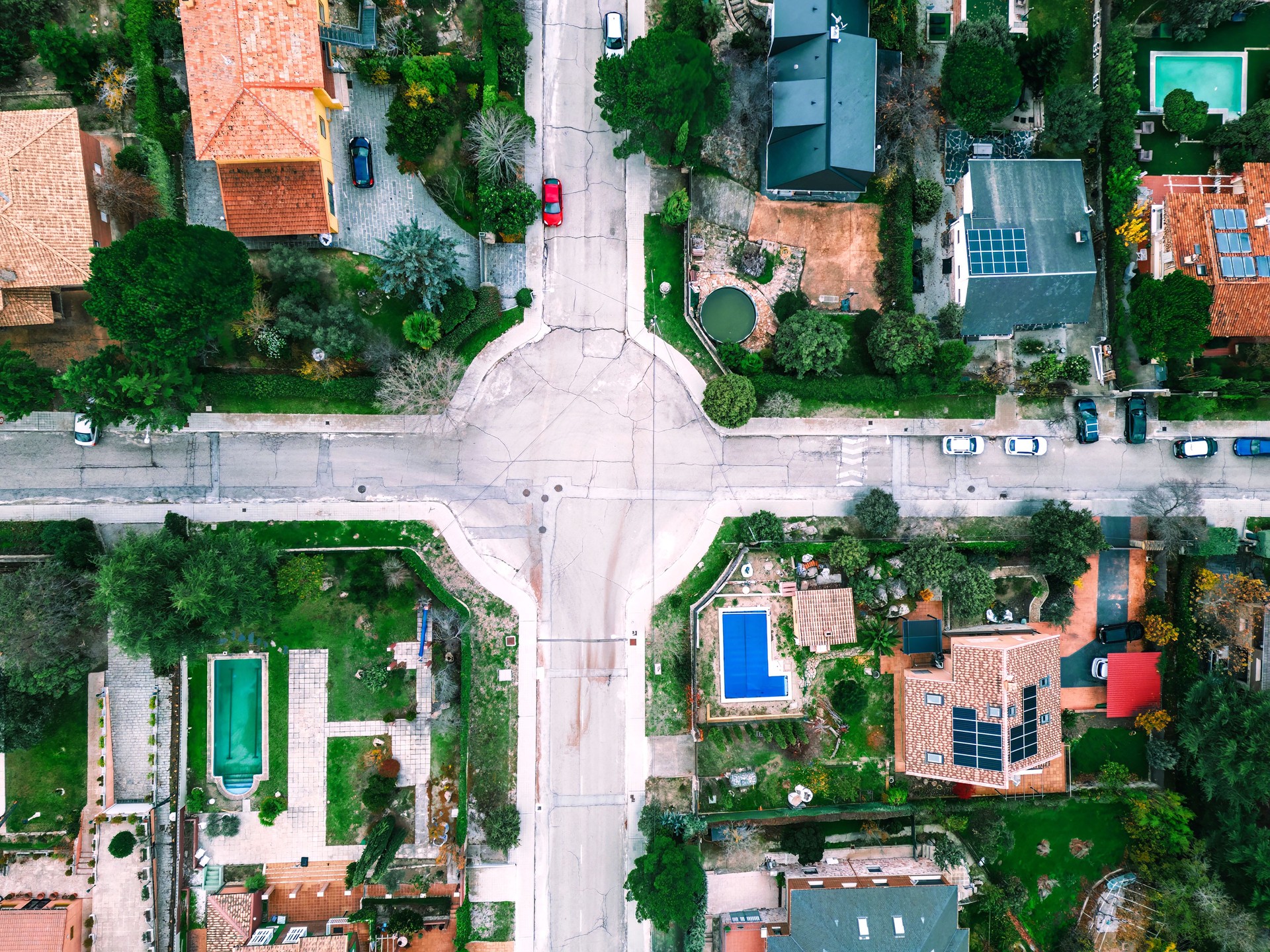 Top Down aerial photos over a residential suburban neighbourhood with solar panels and roadways and parks